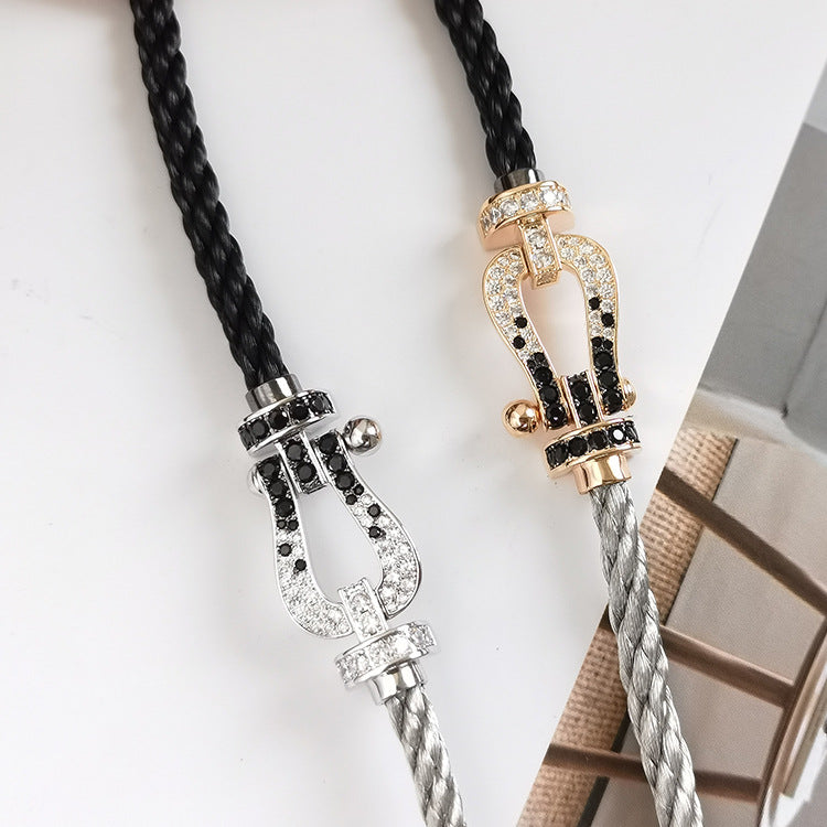[BLAUE TRÄNEN]FORCE GROSSES HUFEISENARMBAND MIT SCHWARZEN WEISSEN DIAMANTEN UND ROSÉGOLD