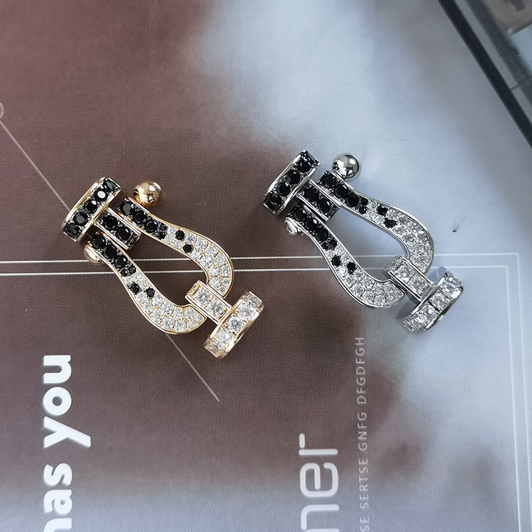 [BLAUE TRÄNEN]FORCE GROSSES HUFEISENARMBAND MIT SCHWARZEN WEISSEN DIAMANTEN UND ROSÉGOLD